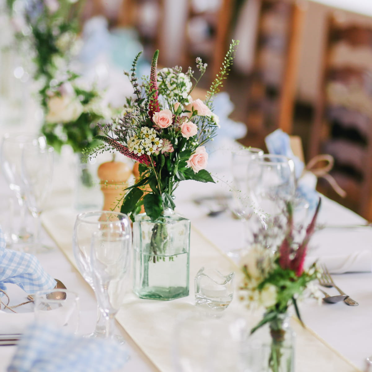 Several floral arrangements on the wedding table setting announce the wedding flower packages product category.