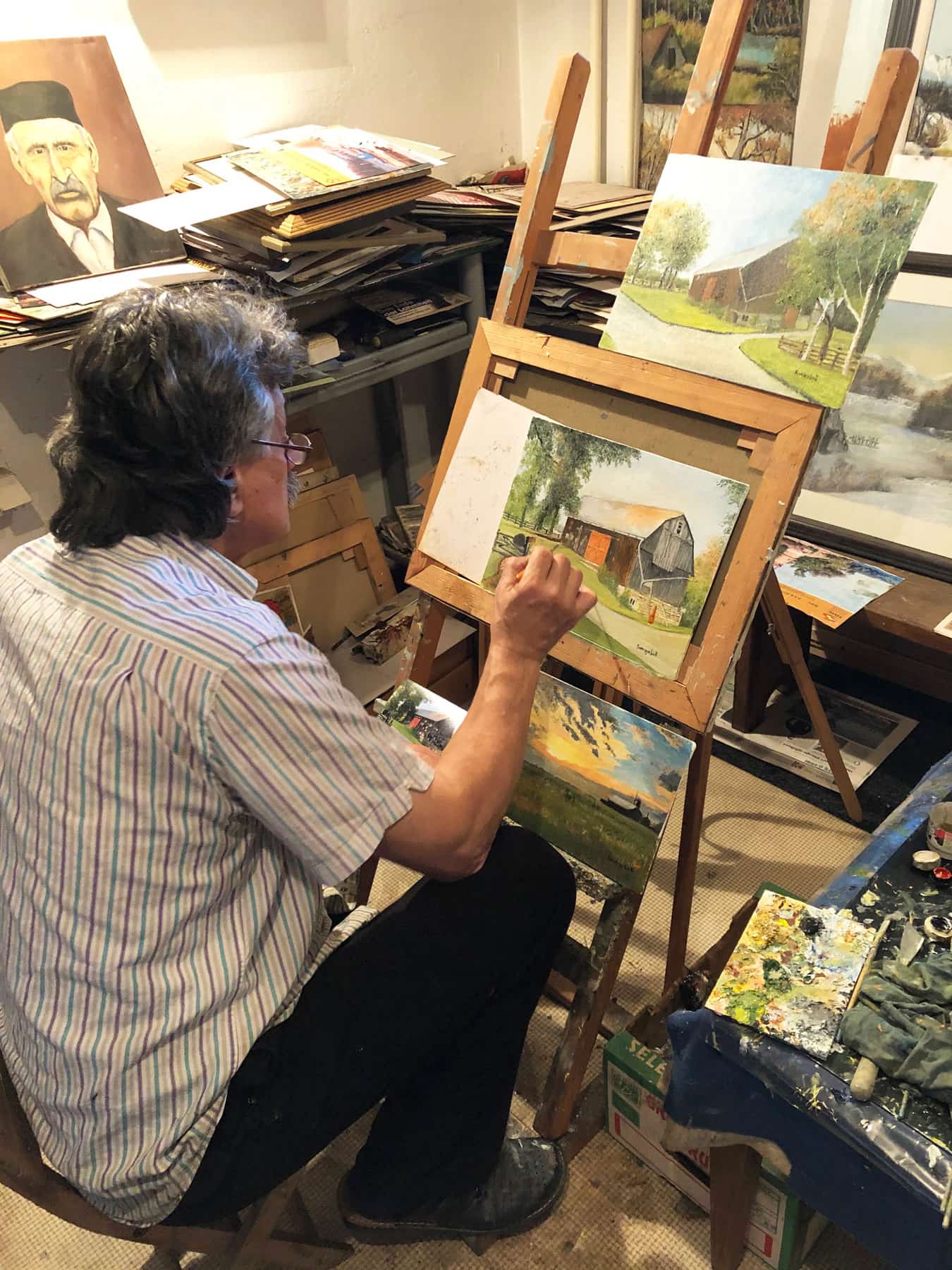 An artist paints Uxbridge motifs for Old Barn Flower Farm and their greeting cards.